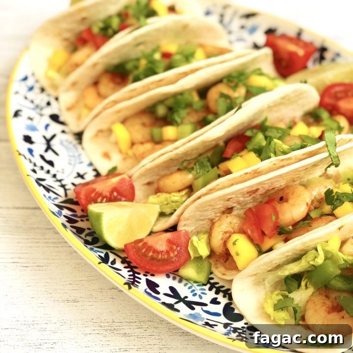 cajun prawn tacos with mango salsa served on blue and white platter