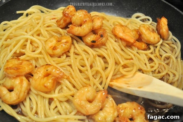 Shrimp added to pasta and sauce Shrimp added to pasta and sauce