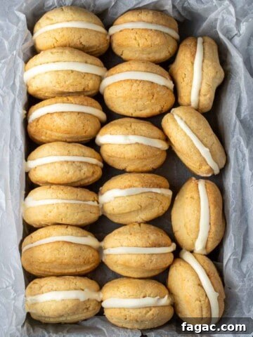 Condensed milk cookies lined up in a baking tray wrapped with baking paper.
