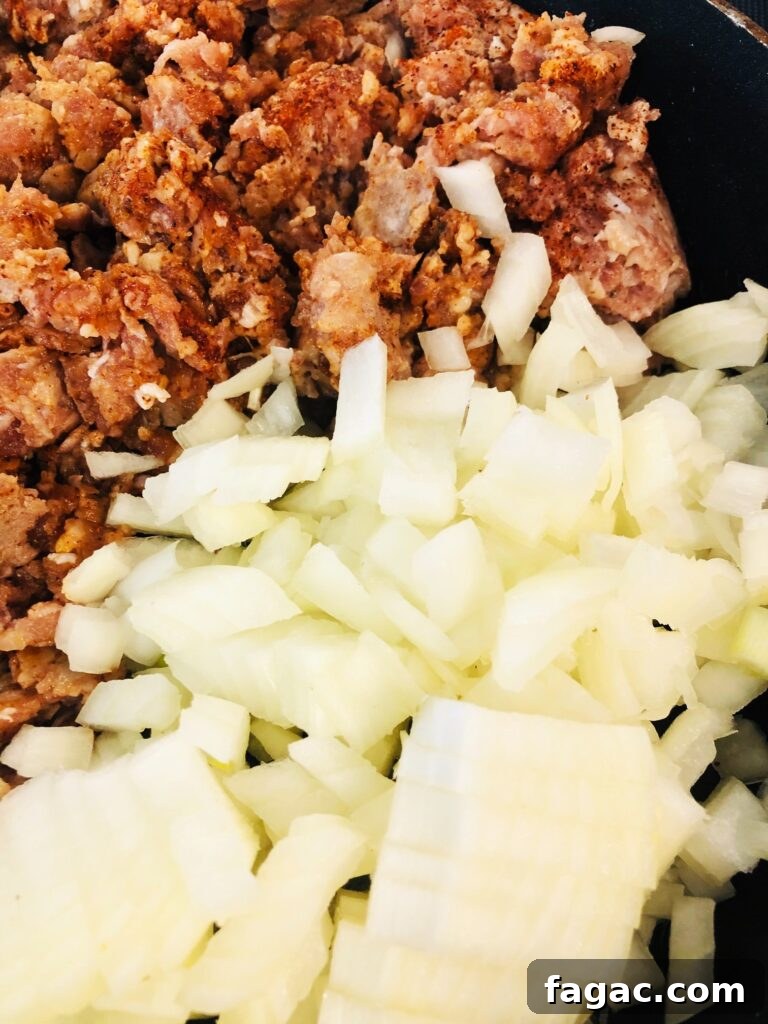 Smoked Sausage and Beer Cheese Dip Recipe 2 sausage and onion in skillet for smoked sausage beer cheese dip