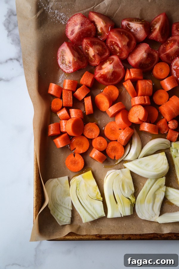 tomatoes carrots and fennel on a sheet pan