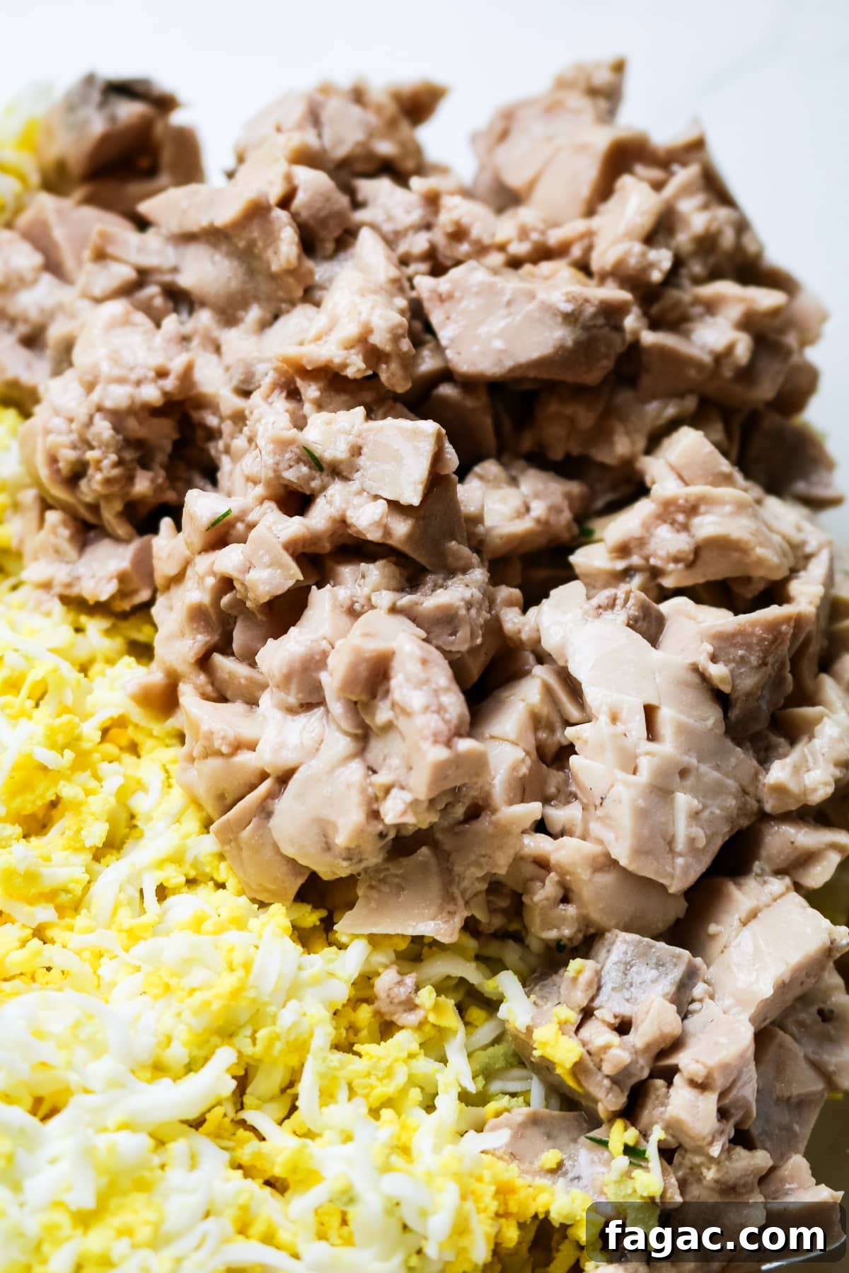 Cod Liver and Egg Salad Recipe: Creamy, Tangy Seafood Salad 8 diced canned cod livers on top of shredded eggs.