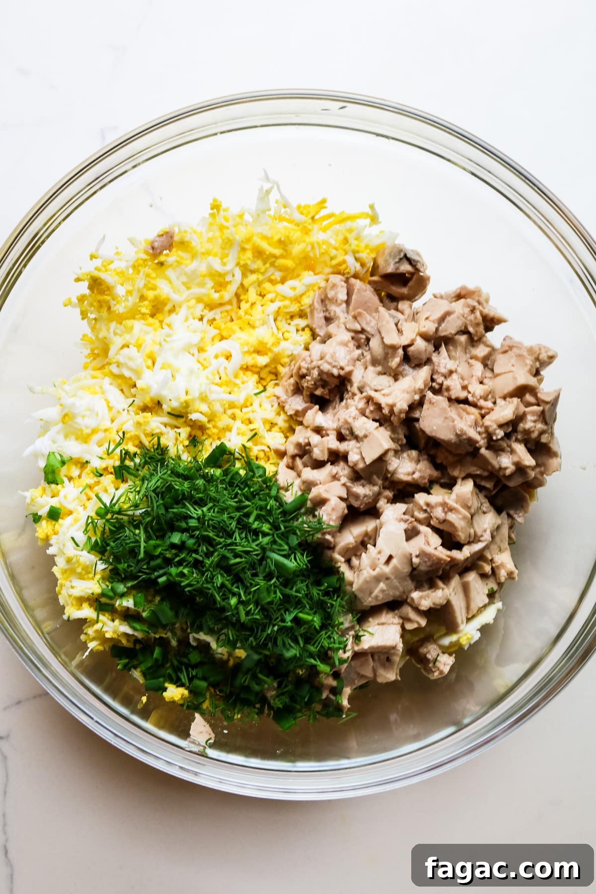 Cod Liver and Egg Salad Recipe: Creamy, Tangy Seafood Salad 9 all prepped ingredients for cod liver salad in a glass bowl.