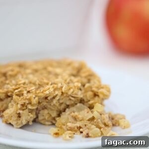 Apple Cinnamon Baked Oatmeal Recipe for Cozy Breakfasts 10 One piece of Baked Oatmeal with Apples and Cinnamon on a white plate.