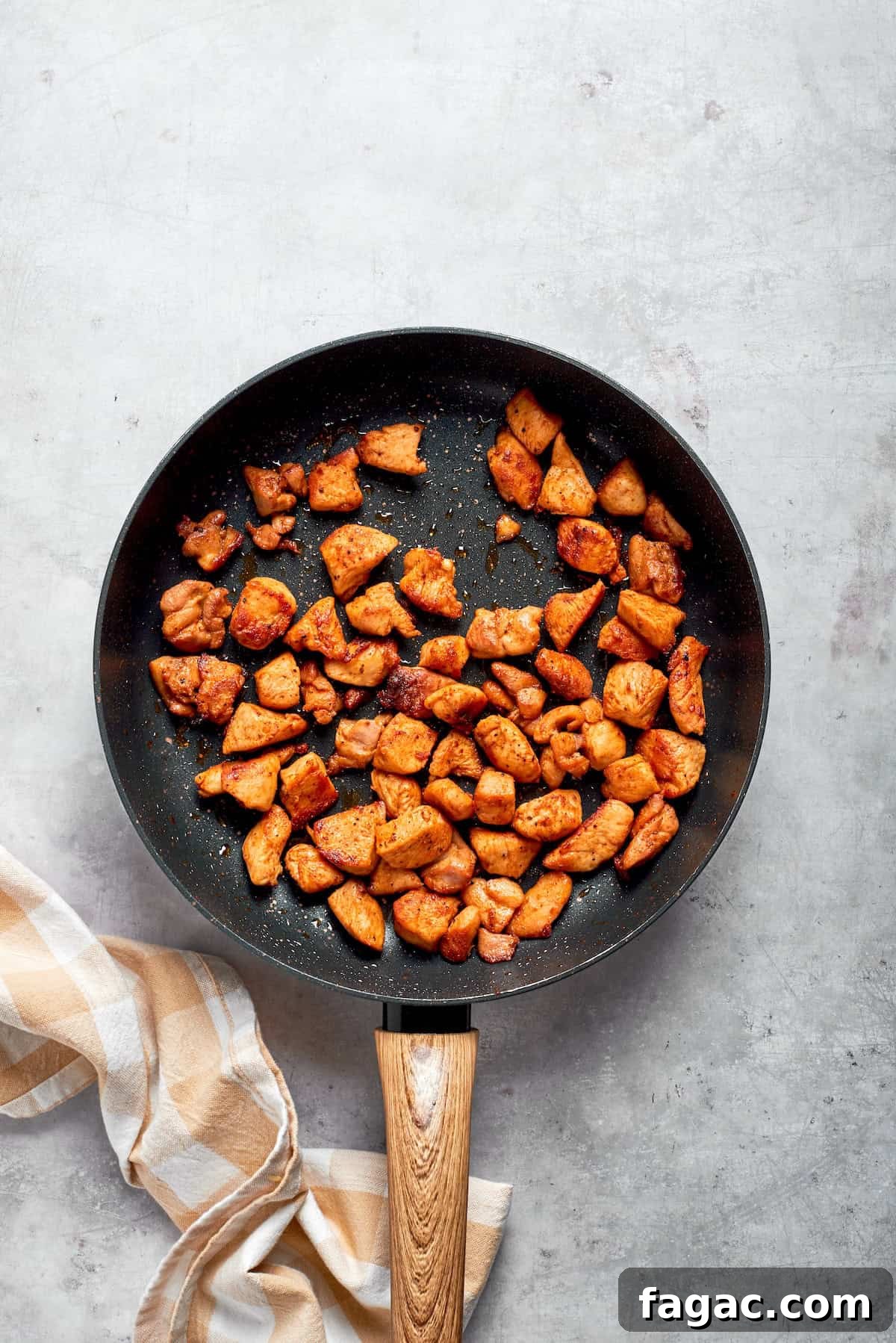 Cook the chicken. Chicken pieces cooked until brown in a skillet.