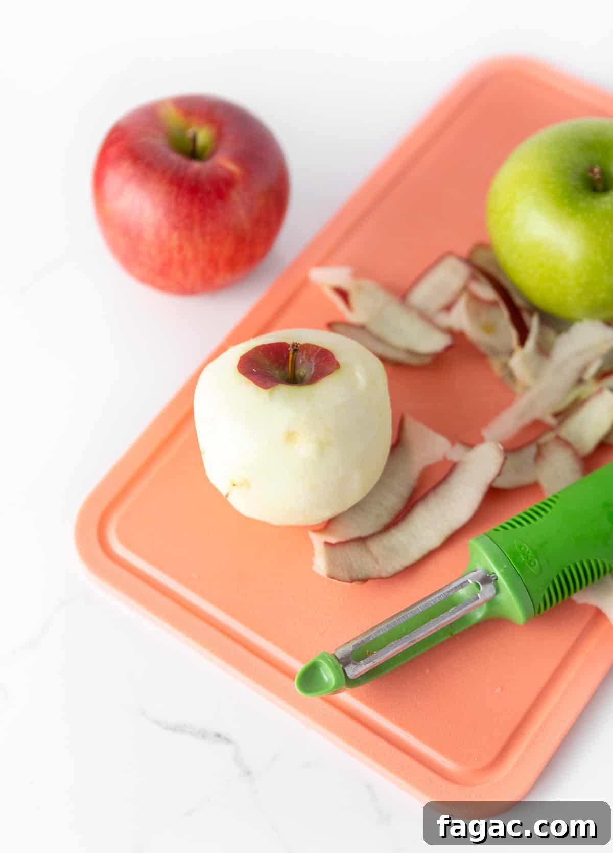 Apple Snickers Salad Recipe: Crunchy Caramel Apple Dessert Salad 7 Pink cutting board peeling red and green apples