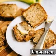 Crispy Sugar-Topped Banana Walnut Bread Recipe 7 Sliced banana walnut bread on a white plate with butter