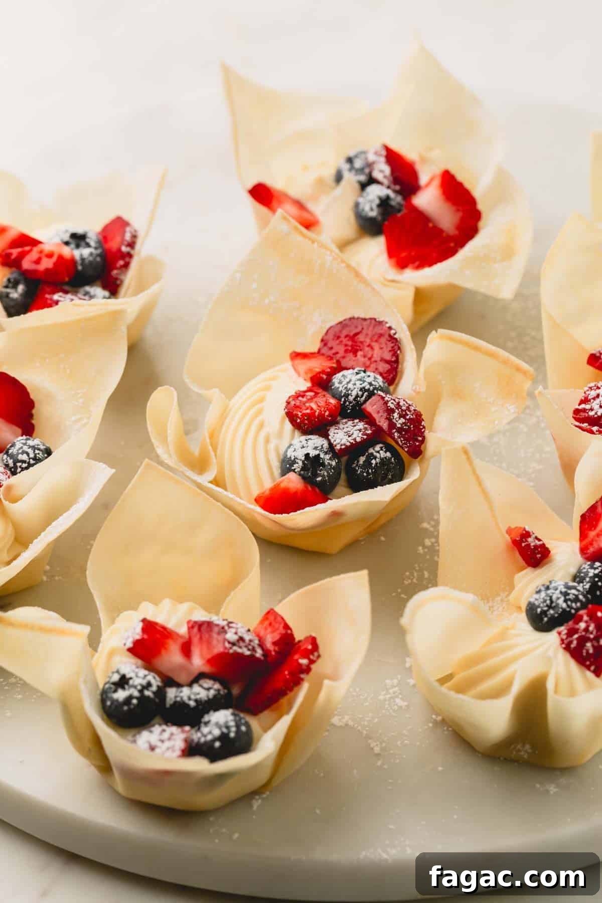 Quick Berry Tartlets: Simple Fresh Fruit Pastry Recipe 3 A plate of mini berry tartlets made with spring roll wrappers.