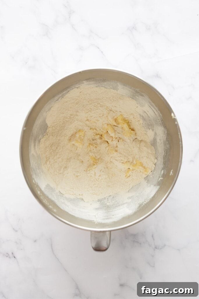 adding flour and baking soda to butter, egg, sugar mixture