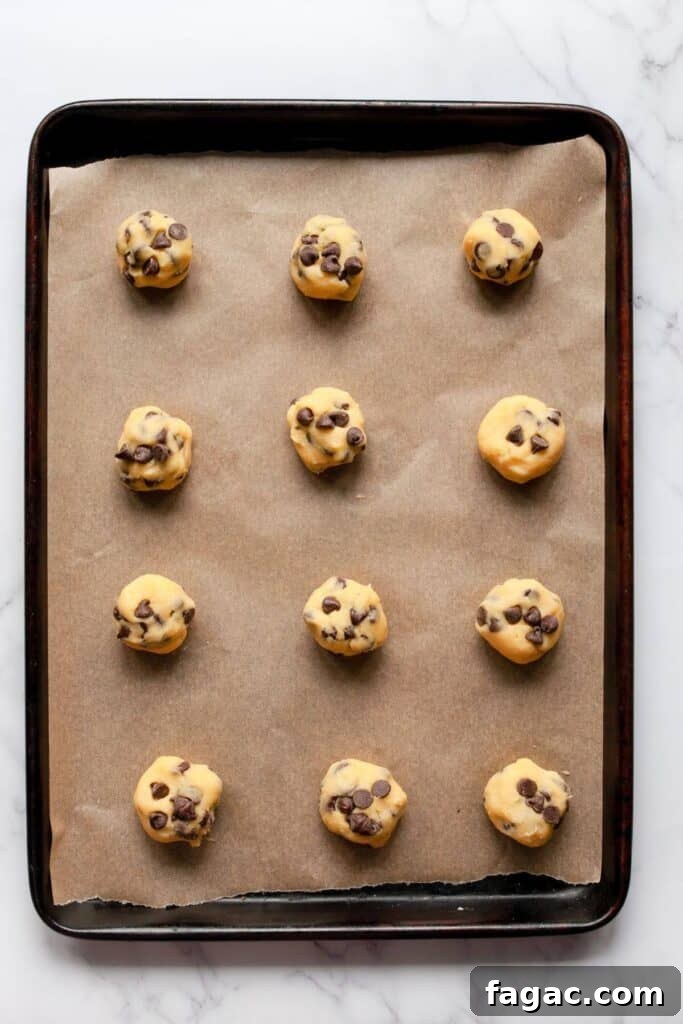 12chocolate chip cookies without brown sugar balls on a baking sheet before baking