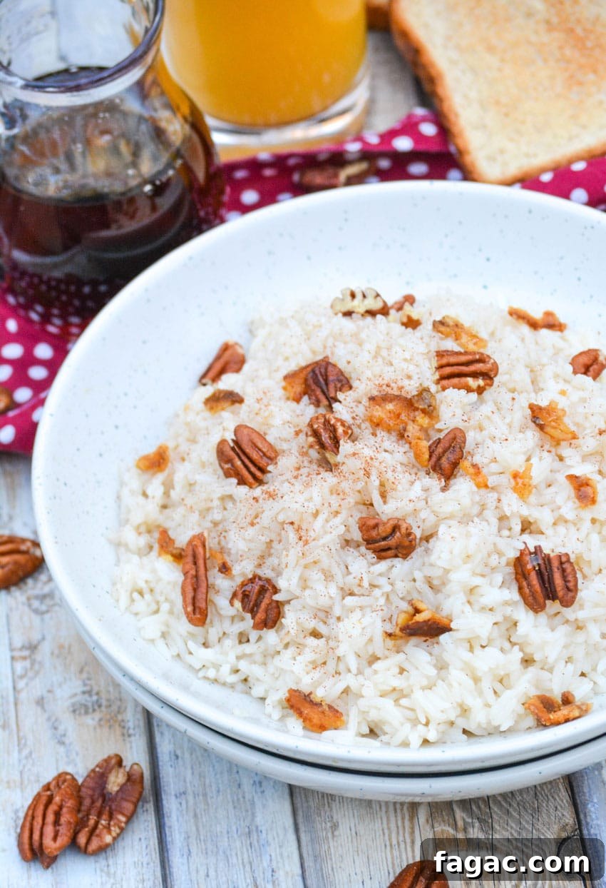 Savory Breakfast Rice Bowl with Veggies and Eggs 2 breakfast rice in a white bowl topped with pecans and crumbled bacon