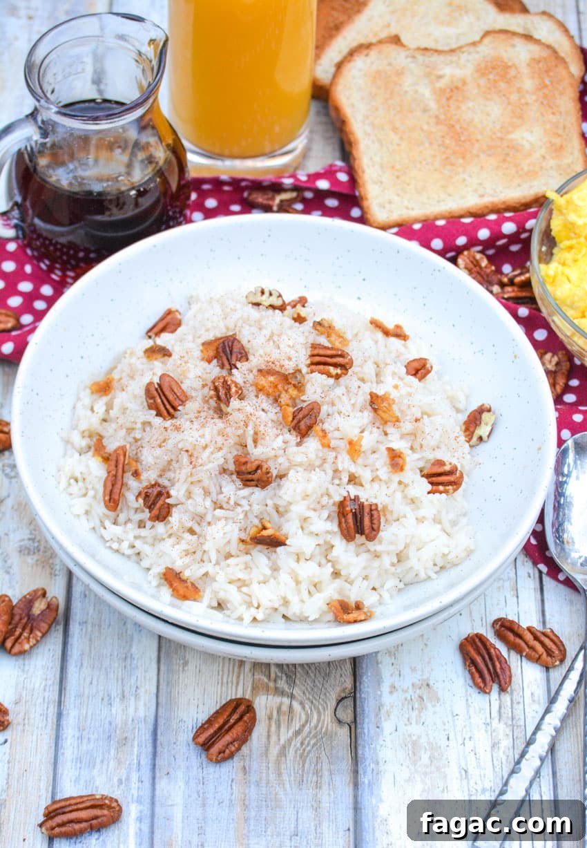 Savory Breakfast Rice Bowl with Veggies and Eggs 3 breakfast rice in a white bowl topped with pecans and crumbled bacon