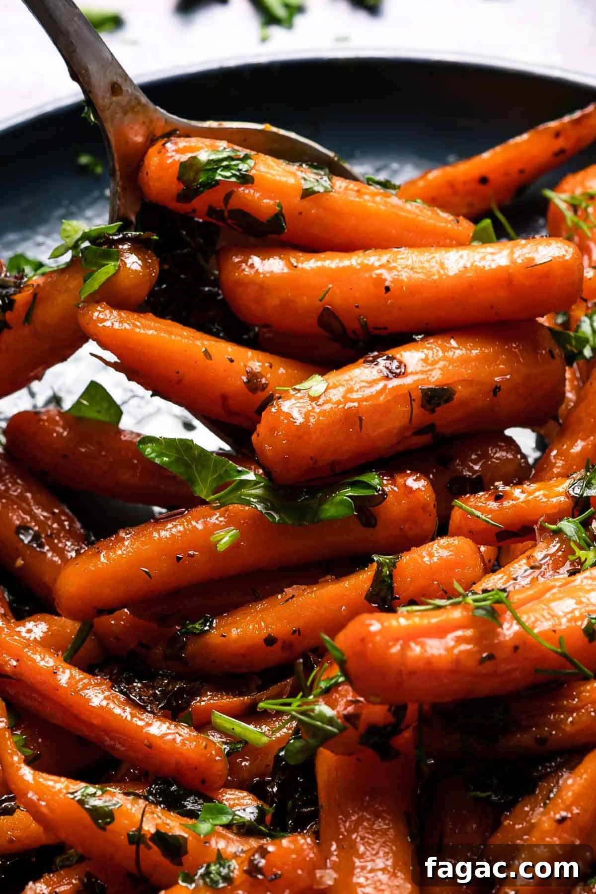 Honey-Glazed Orange Carrots with Citrus Butter Glaze 13 honey orange glazed carrots on plate with spoon