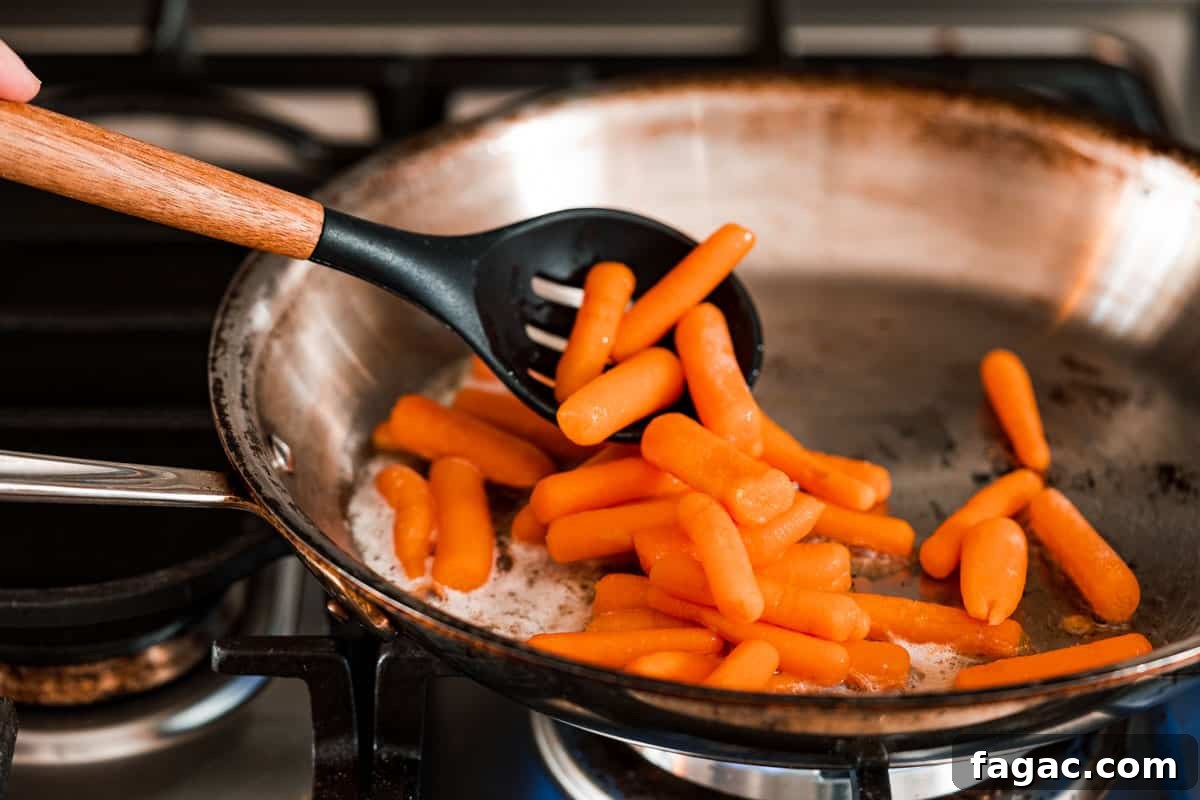 Honey-Glazed Orange Carrots with Citrus Butter Glaze 9 carrots being added to pan on stovetop