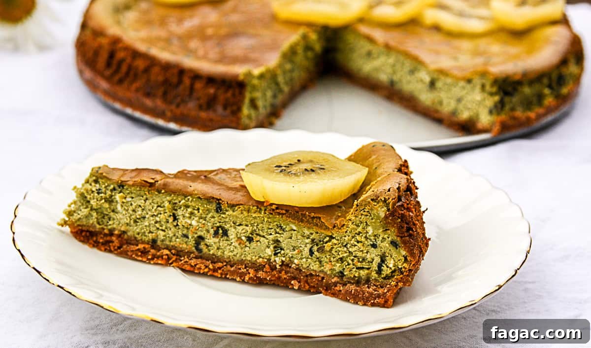 Creamy Matcha Green Tea Cheesecake Recipe 8 A slice of matcha cheesecake on a white plate.