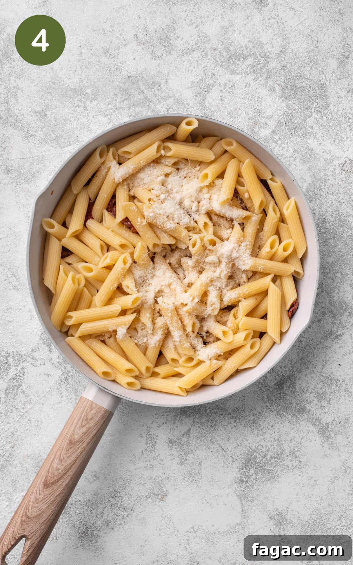 Sun-Dried Tomato Pasta with Garlic, Basil & Parmesan 7 adding pasta with grated parmesan cheese to the pan.