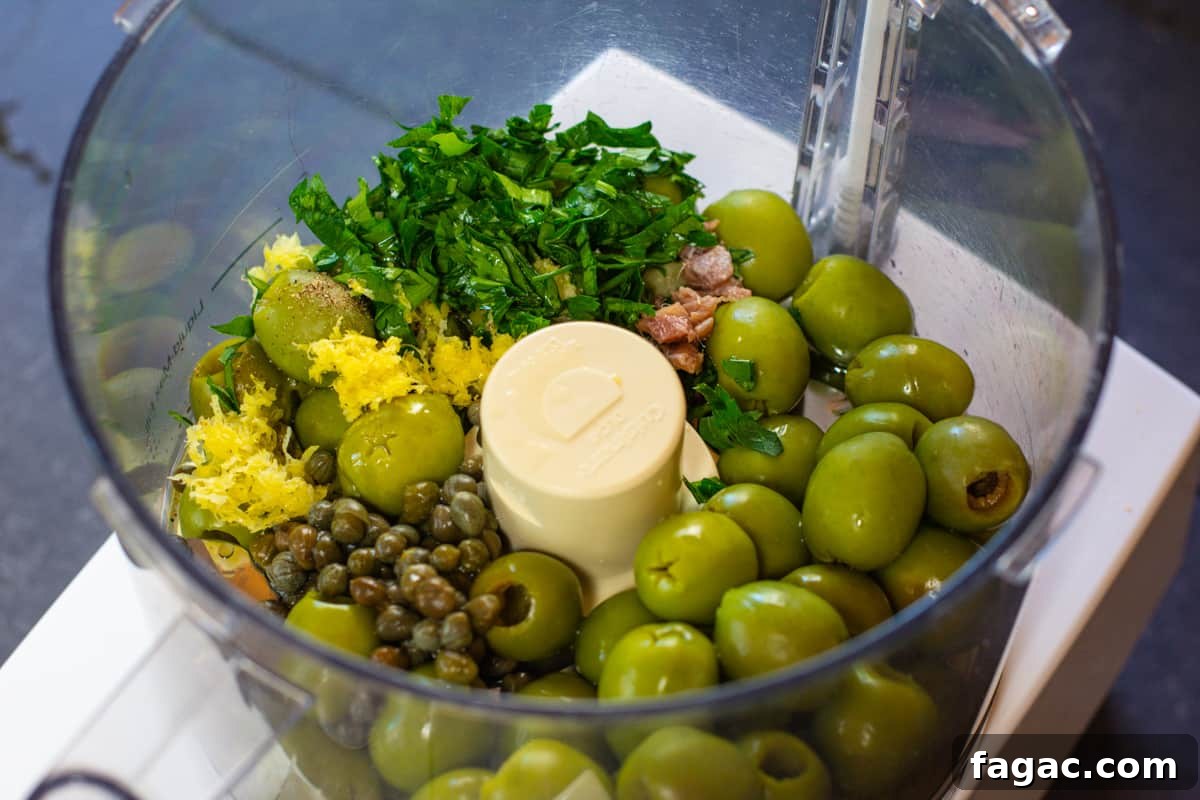 Green Olive Tapenade Ingredients in a food processor.