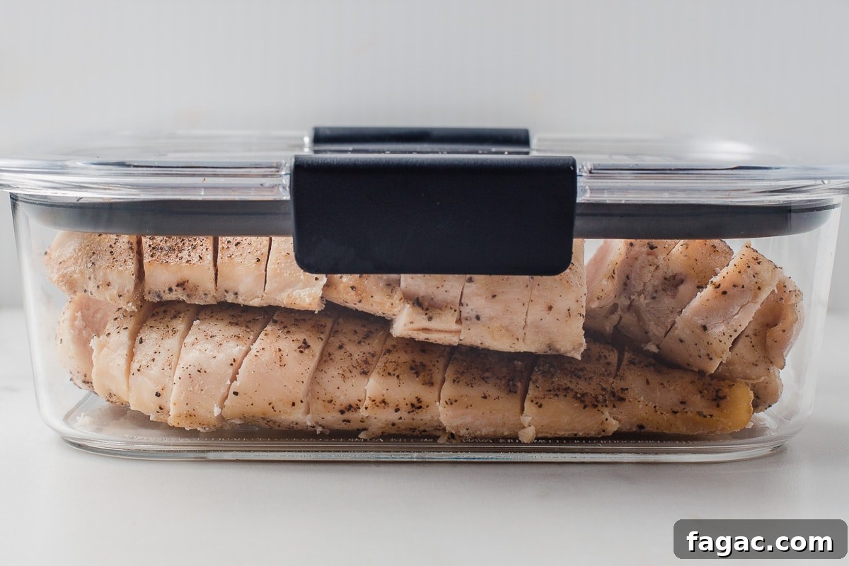 Juicy Oven-Baked Chicken Breasts with Garlic and Herbs 8 Baked chicken breast in a meal prep container.