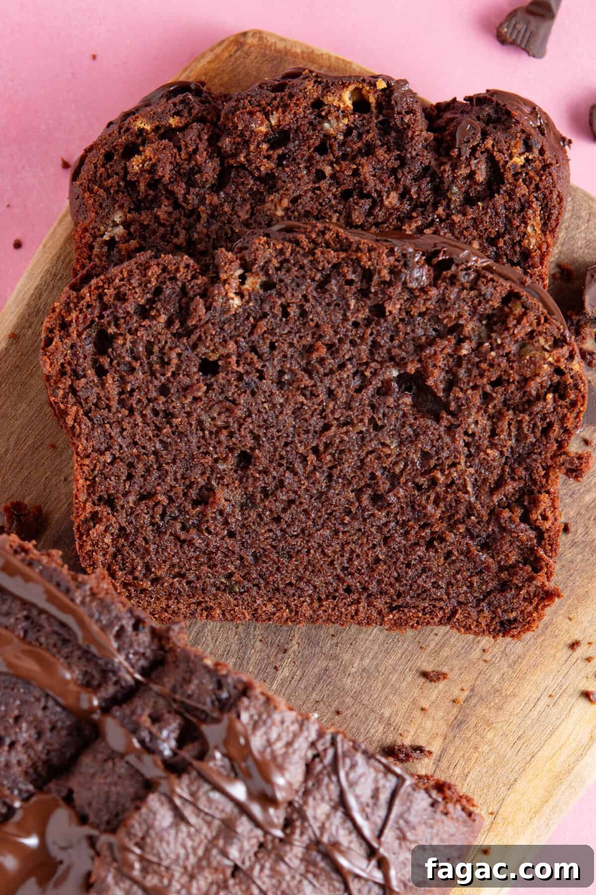 Moist Chocolate Zucchini Cake Recipe 2 Slices of a gluten free chocolate courgette cake on a board.