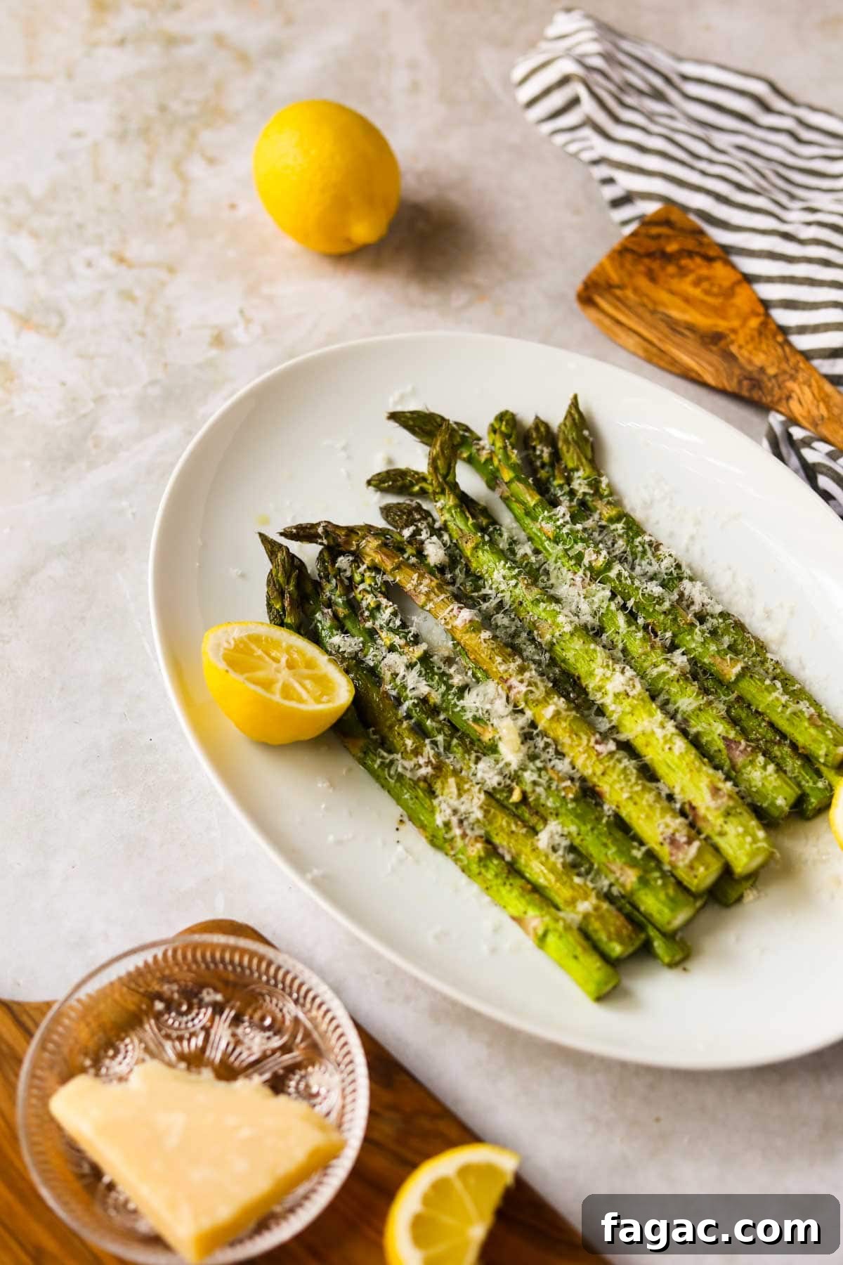 20 Tasty Sides to Serve with Burgers (Healthy Options Included) 11 Roasted Asparagus with Parmesan and Lemon on plate.