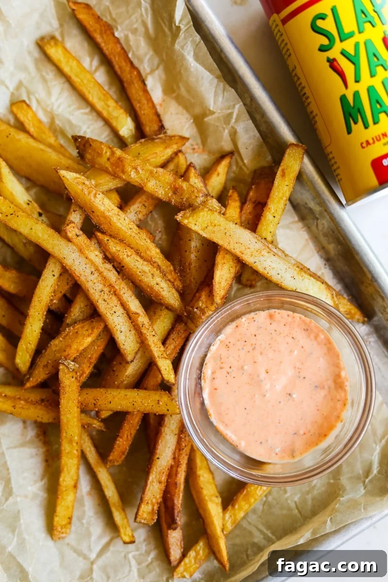 20 Tasty Sides to Serve with Burgers (Healthy Options Included) 12 Spicy cajun fries in a tray with spicy Sriracha aioli and Slap Ya Mama cajun seasoning.