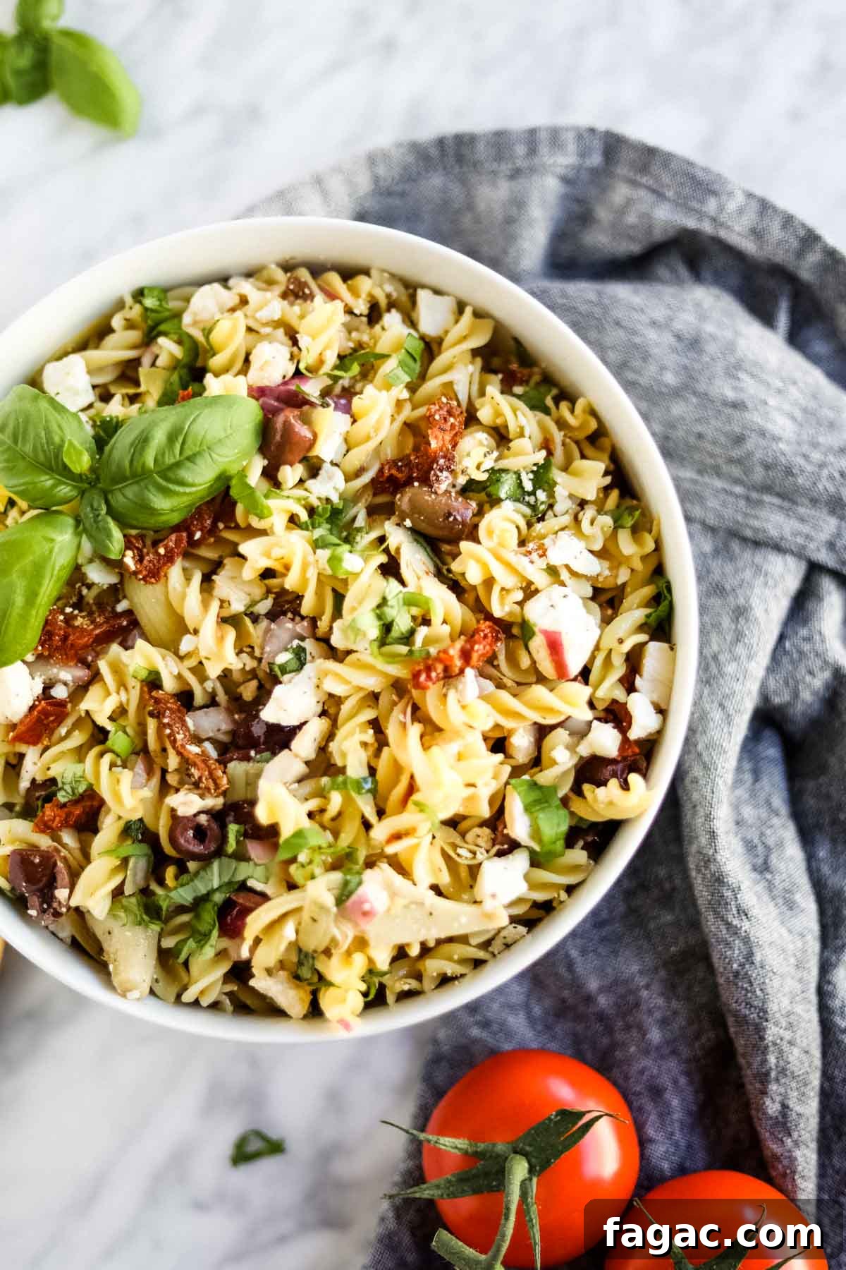 20 Tasty Sides to Serve with Burgers (Healthy Options Included) 13 Pasta salad with Italian ingredients in bowl flatlay.