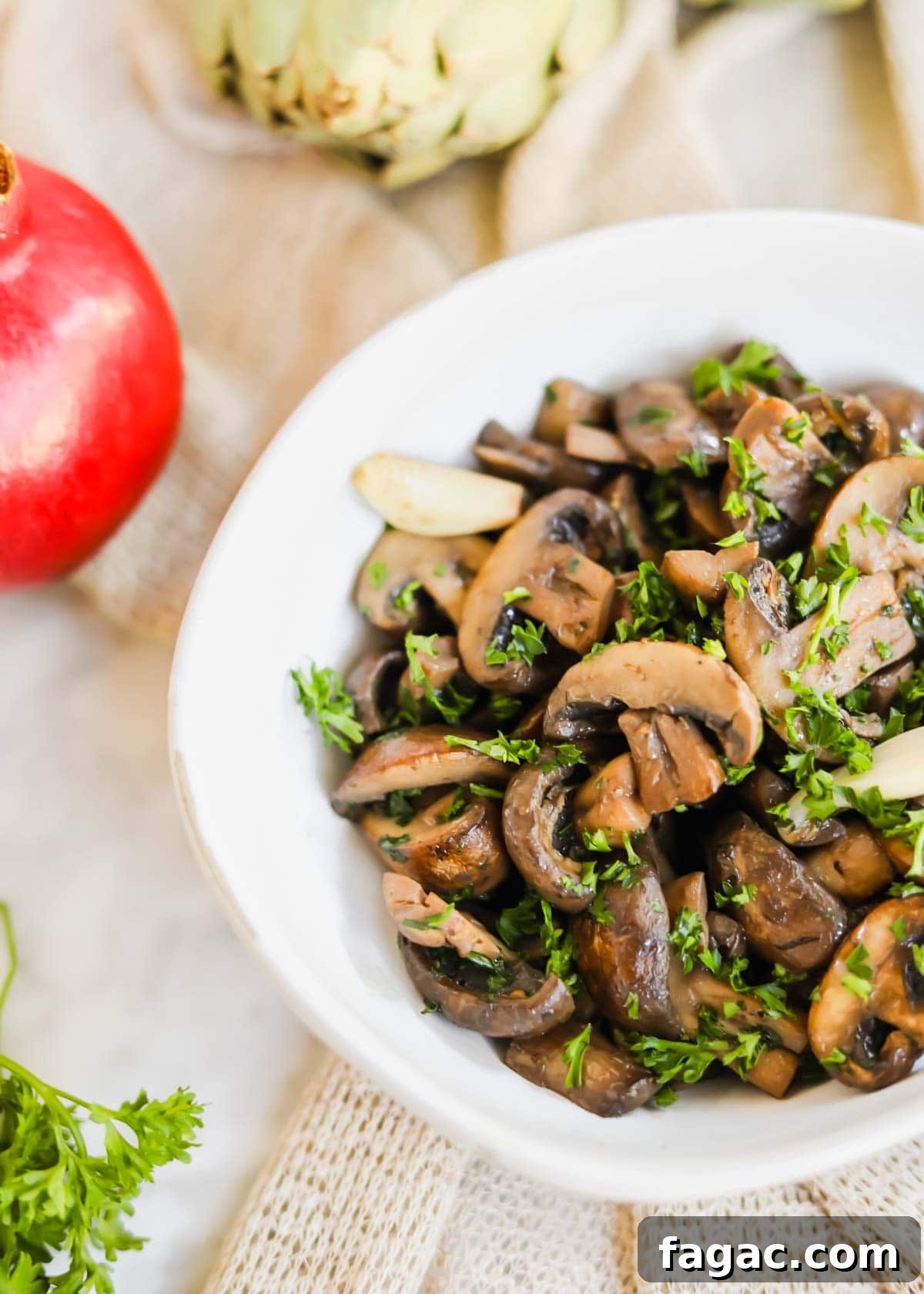 20 Tasty Sides to Serve with Burgers (Healthy Options Included) 19 Sautéed mushrooms with White Wine in white bowl with parsley, garlic, and seasoning.