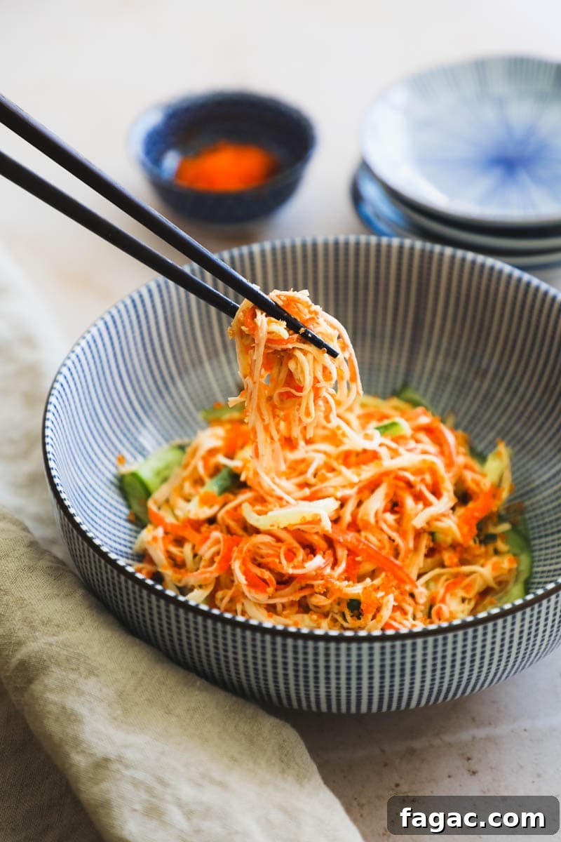 20 Tasty Sides to Serve with Burgers (Healthy Options Included) 21 Chopsticks lifting a bite of Spicy Kani Salad out of a blue Japanese bowl.