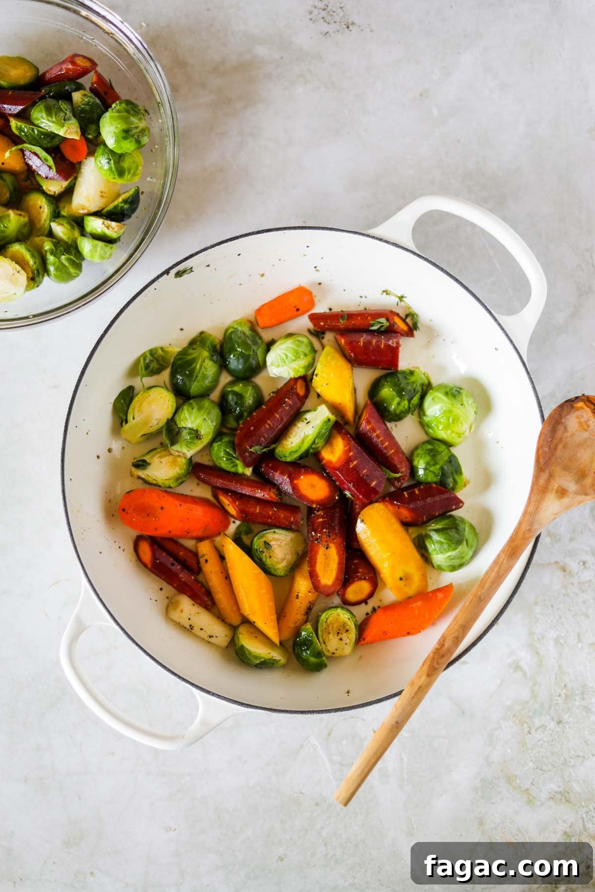 20 Tasty Sides to Serve with Burgers (Healthy Options Included) 22 Brussel Sprouts and Carrots in a white Le Creuset braiser with a wooden spoon.