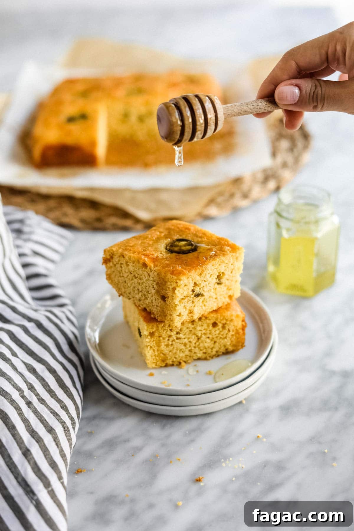 20 Tasty Sides to Serve with Burgers (Healthy Options Included) 5 Jalapeño Cheddar Cornbread with Miso sliced on plate with butter and honey.