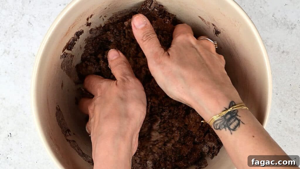 rubbing melted butter into flour, sugar and cocoa powder