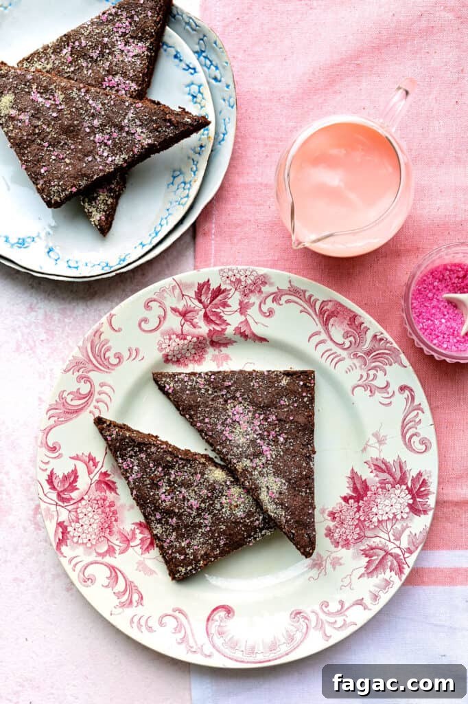 overhead shot of two plates with triangles of chocolate concrete with pink custard jug on the side