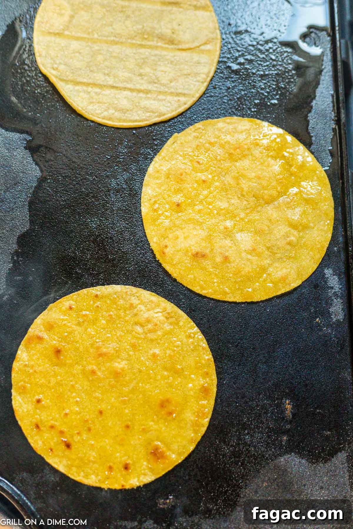 Placing corn tortillas on grill.