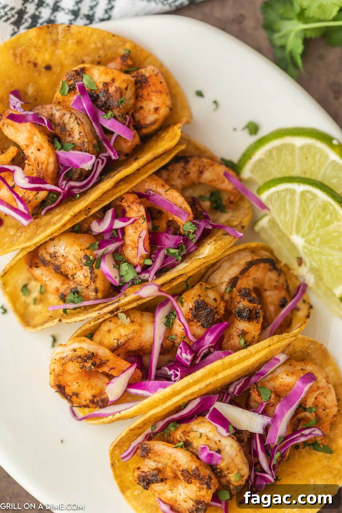 Grilled Shrimp Tacos on a plate topped with cabbage.