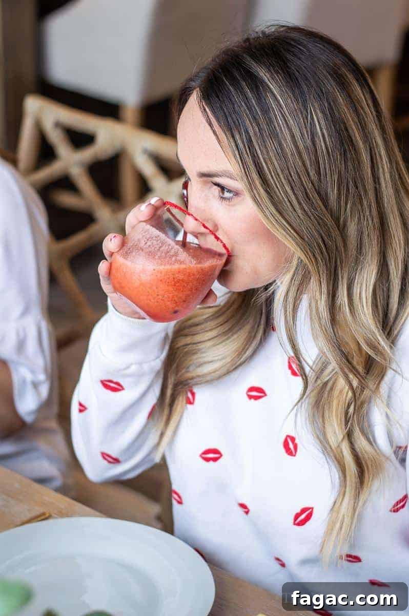 Virgin Strawberry Margarita Mocktail being drunk by a woman