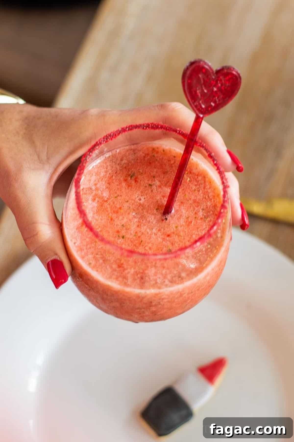 Virgin Strawberry Margarita Mocktail in a hand