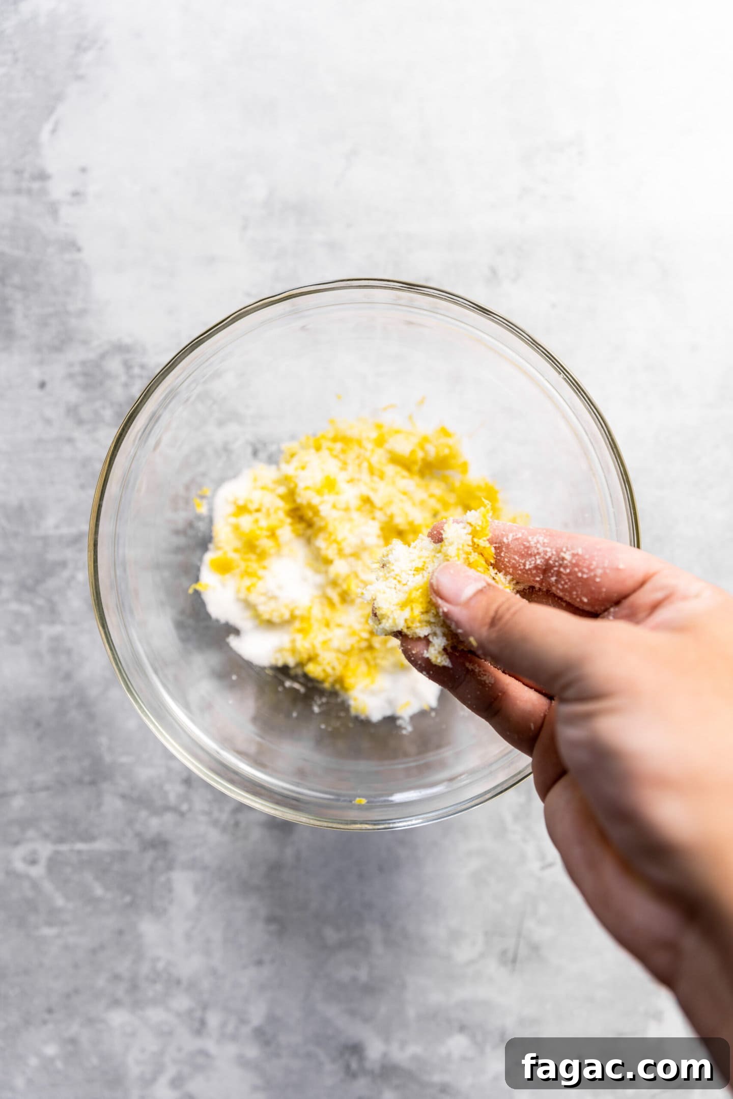 Lemon zest being rubbed into sugar