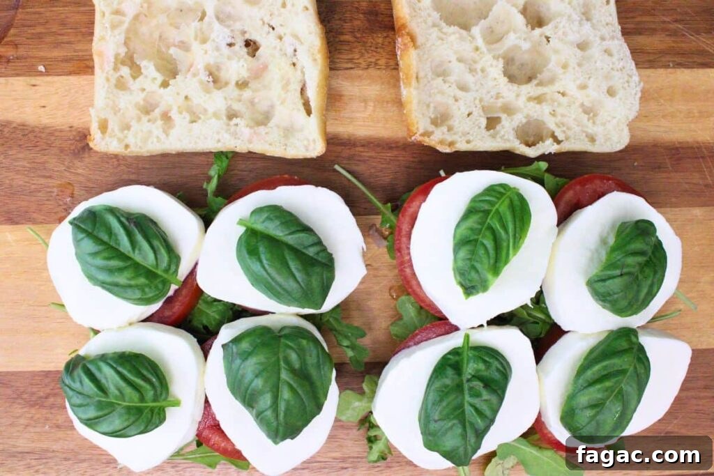 add arugula, tomato, basil, and mozzarella to ciabatta