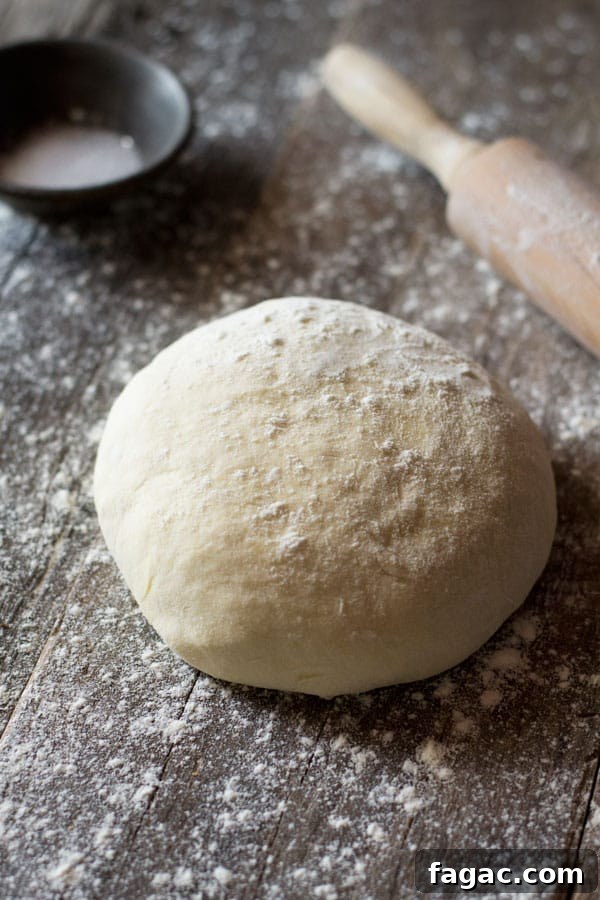 Yeast free pizza dough on a wooden surface with flour at the side