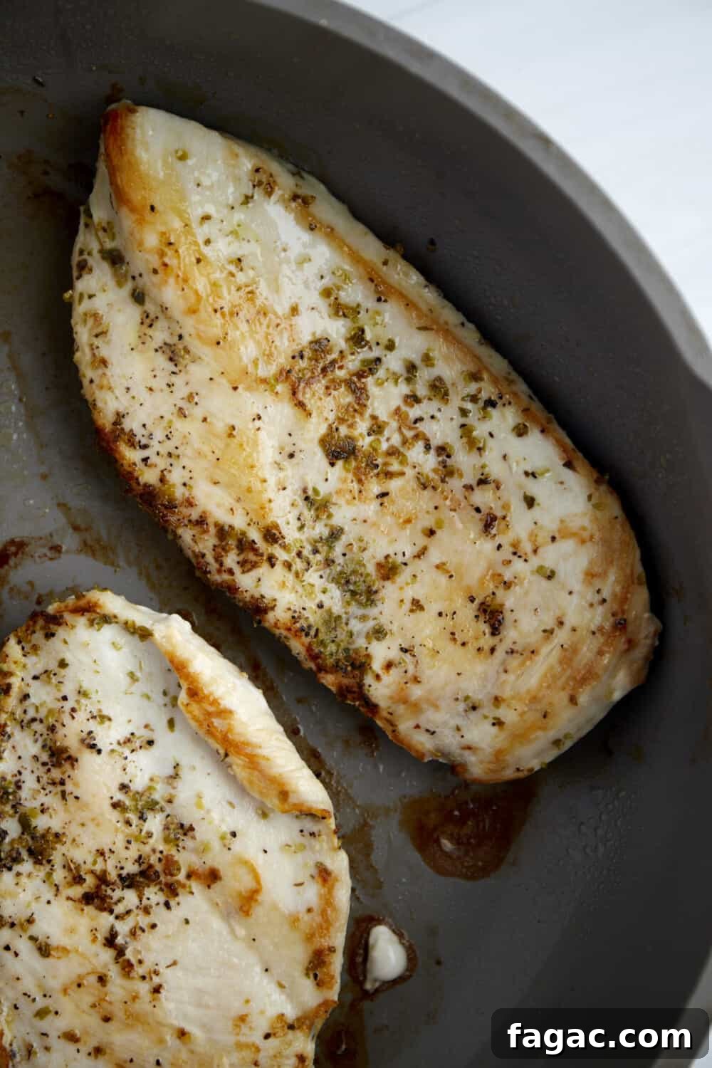 Creamy Parmesan Chicken Recipe – Tender Garlic Butter Chicken 4 seasoned cooked chicken breasts in a skillet