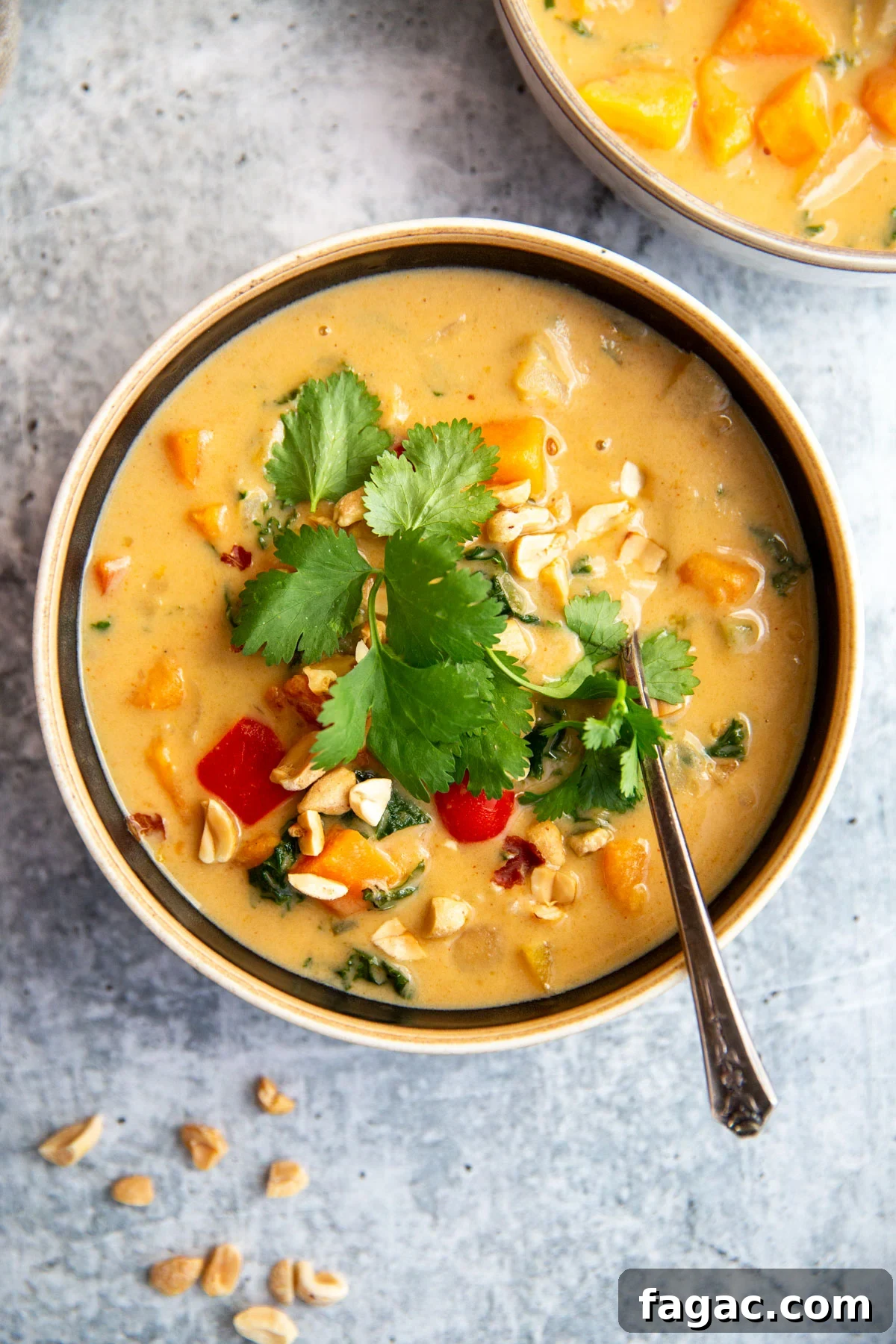 sweet potato peanut stew in a bowl topped with herbs