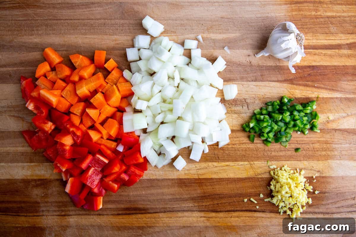 diced veggies on a cutting board ready to be used as ingredients in the sweet potato peanut stew