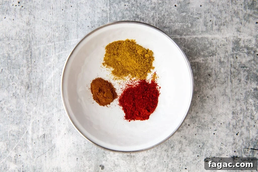 spices measured into a white bowl for the sweet potato peanut stew