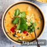 sweet potato peanut stew in a bowl topped with herbs