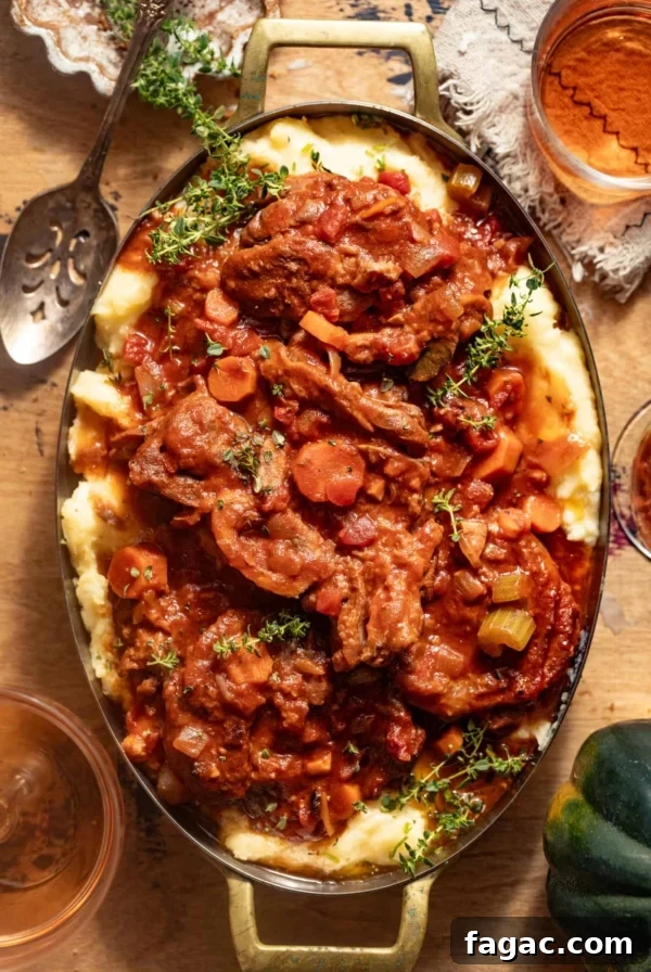 Osso buco over mashed potatoes in a large skillet.