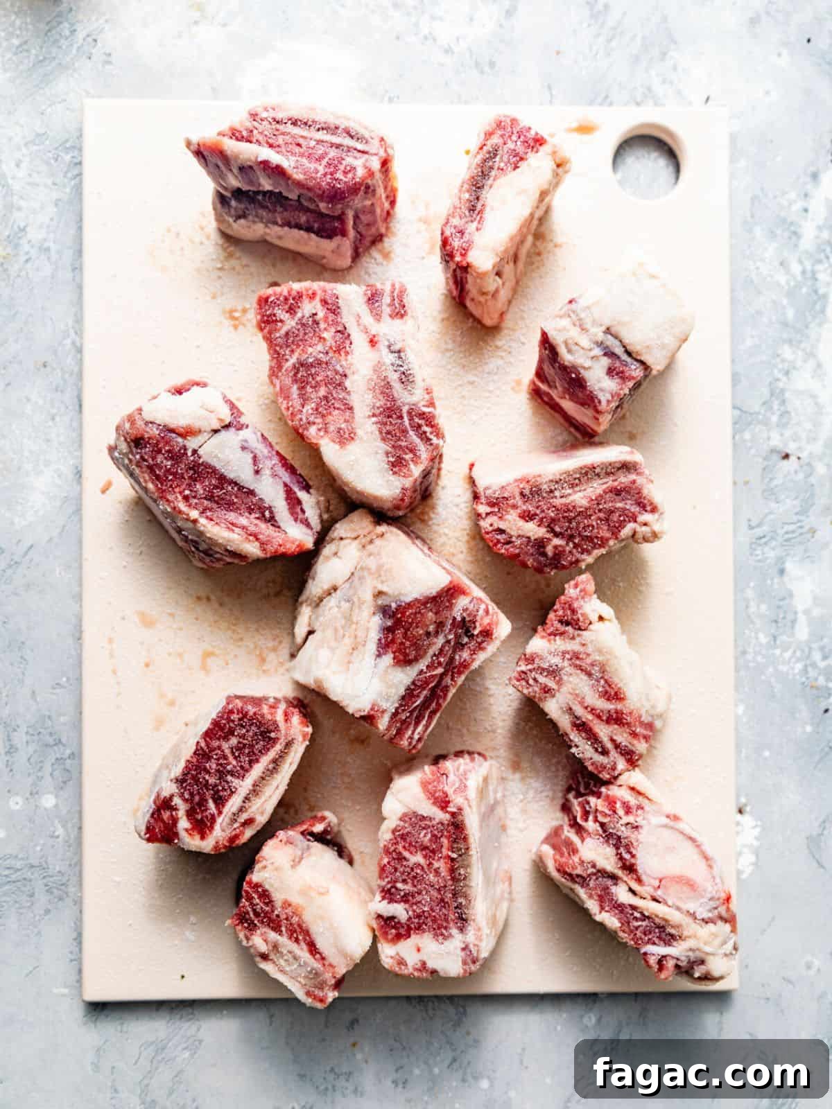 short ribs on a cutting board pat dry with paper towel and seasoned with salt, pepper, and garlic powder.