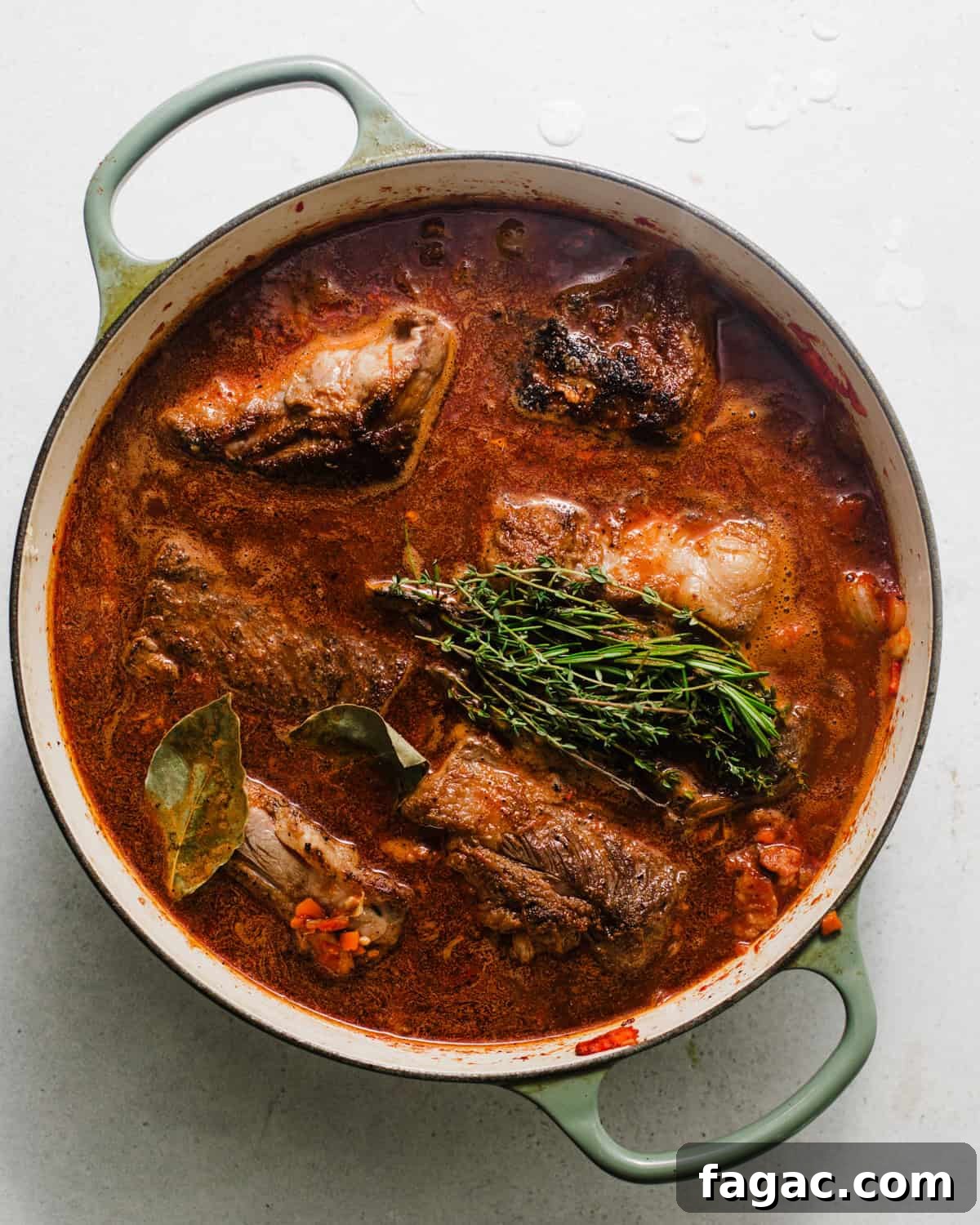 short ribs in a large pot with the braising liquid with fresh herbs.