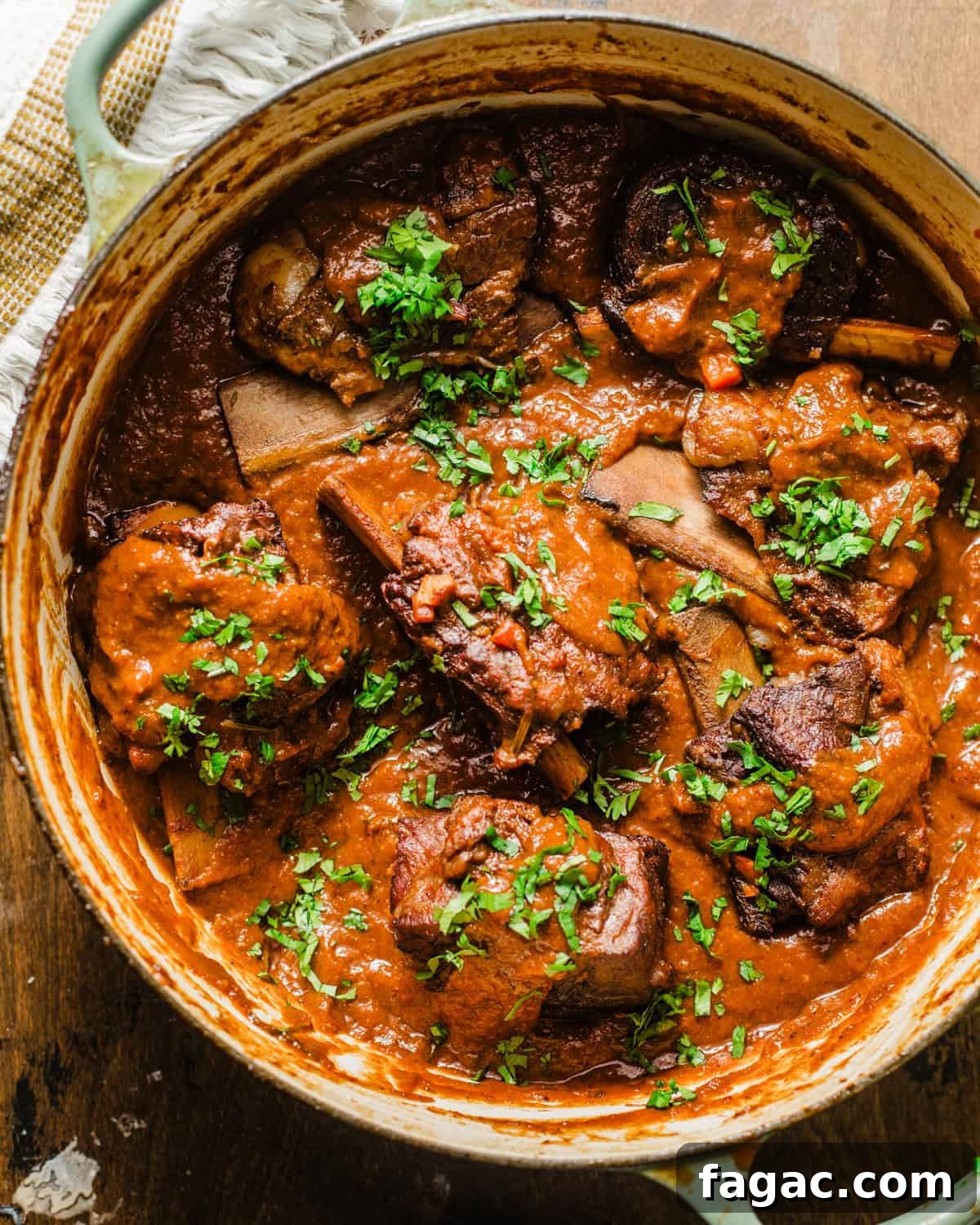 braised short ribs in a pot covered with red wine reduction.