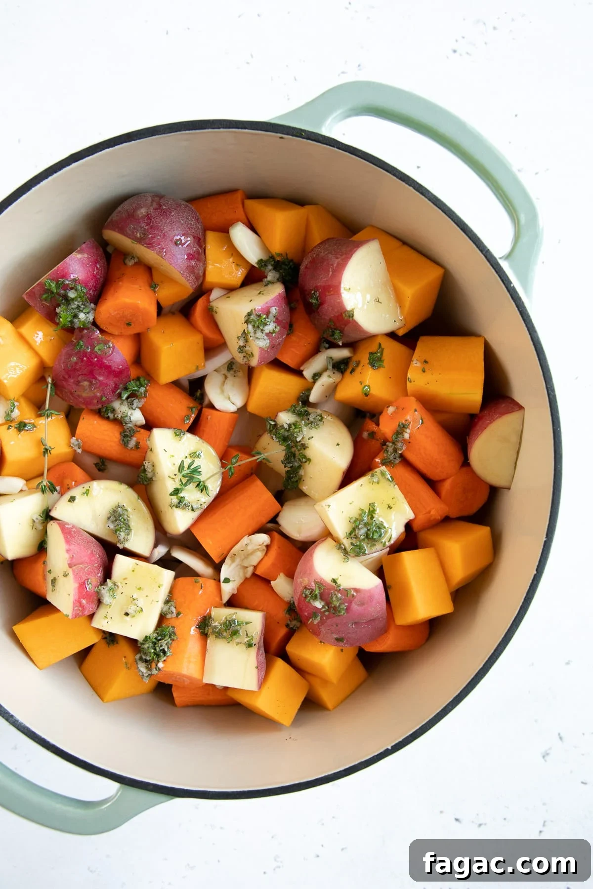 Crispy Roast Chicken with Herb Butter and Lemon 4 Large Dutch oven filled with chopped potatoes, carrots, and butternut squash and drizzled with garlic herb and butter sauce.