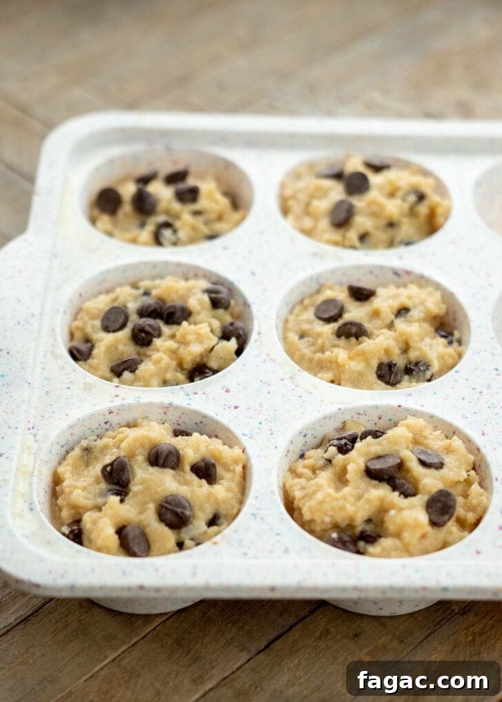 Coconut Flour Muffins: Moist, Low-Carb Recipe for Beginners 11 coconut flour muffin batter spooned into a silicone muffin pan
